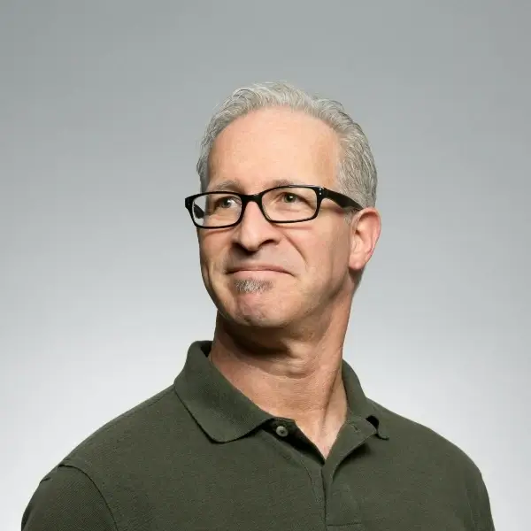 portrait image of a man wearing a green shirt